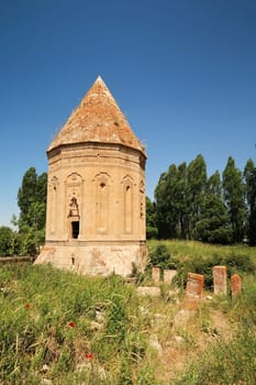 Overgrown little trail lined by tombstones leading to the Halime Hatun tomb, grave, mausoleum, Halime Hatun Kümbeti, close to Lake Van, Van Gölü, Gevas, Turkey 2022