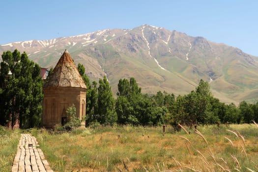 The Halime Hatun tomb, grave, mausoleum, Halime Hatun Kümbeti with the snow covered Mount Artos in the background, close to Lake Van, Van Gölü, Gevas, Turkey 2022