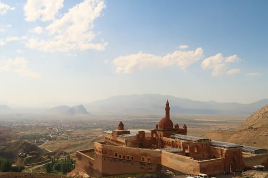 Scenic view onto the Ishak Pasha Palace, Sarayi with the town of Dogubeyazit and the surrounding lanscape in the background, Dogubeyazit, Turkey 2022