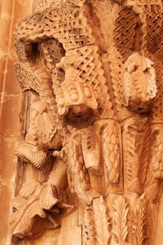 Elaborate floral, flower bouquet, plant carvings next to the majestic gate, doorway in the second court inside the Ishak Pasha Palace, Sarayi, Dogubeyazit, Turkey 2022