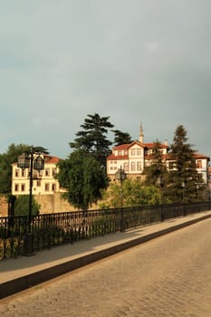 The beautiful Zagnos Pasha Bridge, Zagnos Pasa Köprüsü, cobble stone street, old street lantern and railing and traditional houses in the background, Trabzon, Turkey 2022