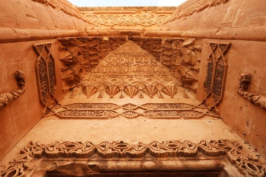The elaborate patterns and details carved into the majestic ottoman gate, doorway seen from the second court inside the Ishak Pasha Palace, Sarayi, Dogubeyazit, Turkey 2022