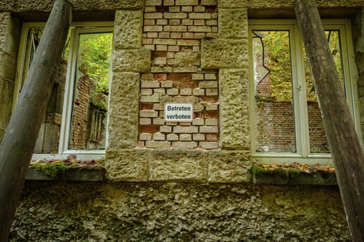 Wall and windows of an old lost place power plant building