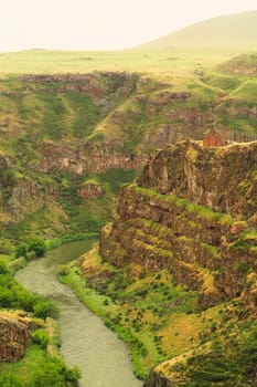 Picturesque view on the promontory encircled by the canyon of the Akhurian River with the ruins of the Church of Saint Elia, Zakares Church on top, last remaining building of the Kizkale, Kiz Kalesi, Maidens, Virgins Castle, ancient site of Ani, Kars, Turkey 2022