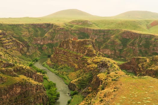 Beautiful view on the promontory encircled by the canyon of the Akhurian River with the ruins of the Church of Saint Elia, Zakares Church on top, last remaining building of the Kizkale, Kiz Kalesi, Maidens, Virgins Castle, ancient site of Ani, Kars, Turkey 2022