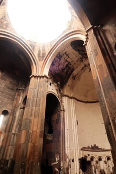 Inside of the Cathedral of Ani, Church of the Holy Mother of God, light is shining through the hole in the ceiling, at the ancient site of Ani, an abandoned ruined armenian city, close to Kars, Turkey 2022
