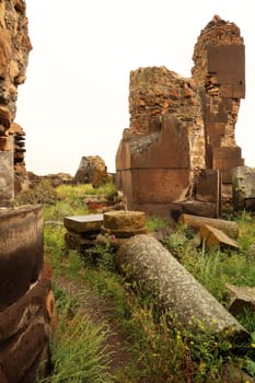 Rocks, bricks and pillars are lying around inside the ruins of King Gagik`s Church of St., Saint Gregory, Gagikashen, at the ancient site of Ani, an abandoned ruined armenian city, close to Kars, Turkey 2022