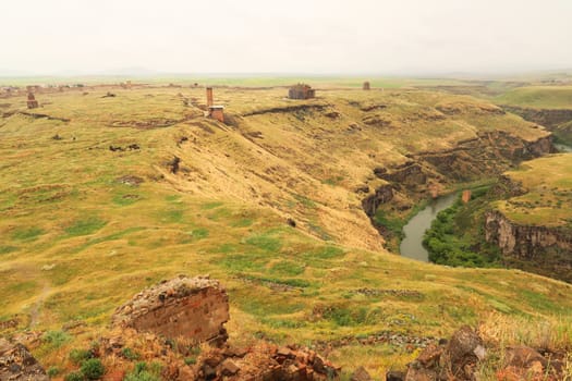 View from the Citadel onto the ancient site of Ani, an abandoned ruined armenian city, the destroyed bridge, the canyon, the Mosque of Minuchihr, the Cathedral, the Tigran Honents Church and the Church of St. Gregory can be seen, Kars, Turkey 2022