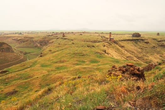 View from the Citadel onto the ancient site of Ani, an abandoned ruined armenian city, the Mosque of Minuchihr, the Cathedral, the Tigran Honents Church, the Church of St. Gregory and the city wall in the far distance can be seen, Kars, Turkey 2022