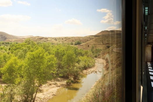 On the train ride in the Eastern Express, Dogu Ekspresi from Kars to Ankara, passing a river, the front of the train is visible, Turkey 2022