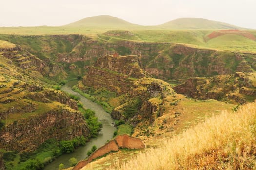 The promontory encircled by of the Akhurian River with the Church of Saint Elia, Zakares Church on top, last remaining building of the Kizkale, Kiz Kalesi, Maidens, Virgins Castle, a part of the citadel wall in the front ancient site of Ani, Kars, Turkey 2022