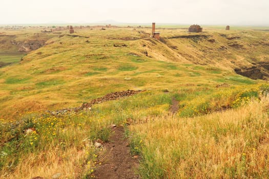 Scenic view from the Citadel onto the ancient site of Ani, an abandoned ruined armenian city, the Mosque of Minuchihr, the Cathedral, the Tigran Honents Church, the Church of St. Gregory and the city wall in the far distance can be seen, Kars, Turkey 2022
