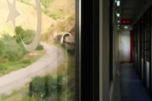On the train ride in the Eastern Express, Dogu Ekspresi from Kars to Ankara, the interior of the train and its front are both visible, the train is entering a tunnel, Turkey 2022
