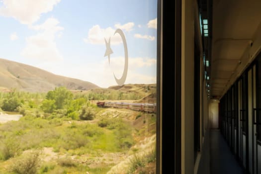 The beautiful landscape seen on the train ride in the Eastern Express, Dogu Ekspresi from Kars to Ankara, the interior of the train and its front are both visible, Turkey 2022