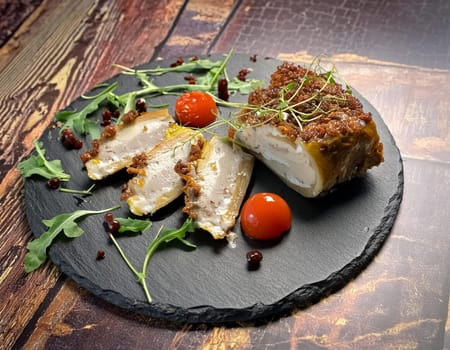 Fried pork with herbs and spices on black stone table. Top view with copy space.