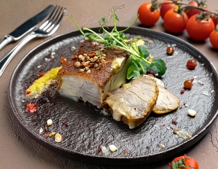 Fried pork with herbs and spices on black stone table. Top view with copy space.