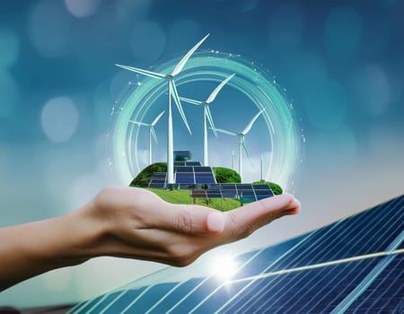 Wind turbine on human hand in front of the sky (Digital Composite)
