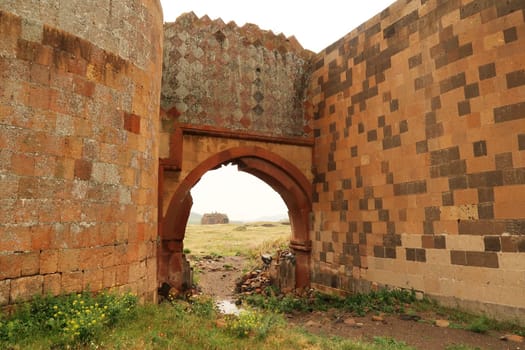 View through the Chequerboard, Chequer-board, chequer board Gate onto the Cathedral of Ani, Church of the Holy Mother of God at the ancient site of Ani, an abandoned ruined armenian city, close to Kars, Turkey 2022