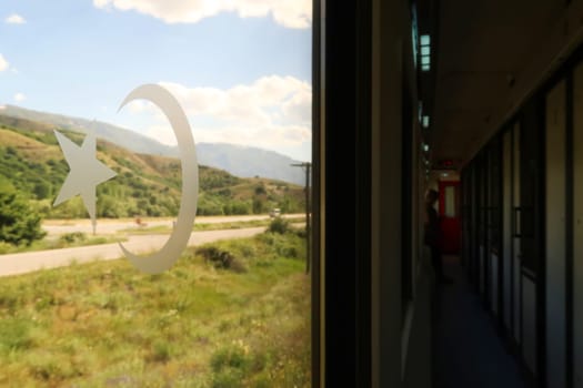 On the train ride in the Eastern Express, Dogu Ekspresi from Kars to Ankara, the interior of the train is visible, a passenger is standing in the aisle, Turkey 2022