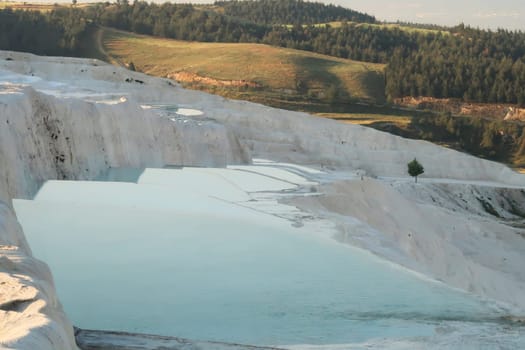 Turquoise blue water in the travertines of Pamukkale early in the morning, Denizli, Turkey 2022