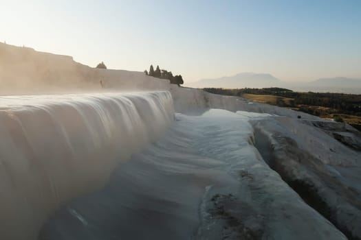 Steaming water running over a travertine terrace at Pamukkale in the early morning, Denizli, Turkey 2022
