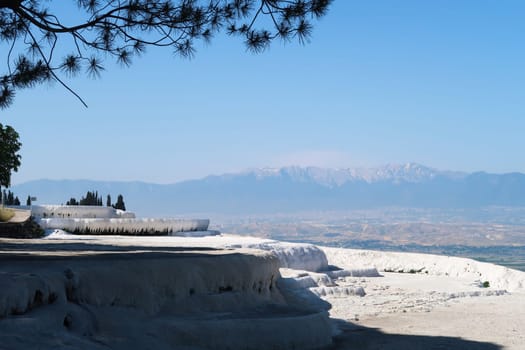 Fantastic view from the travertines of Pamukkale with the valley and the mountains in the background, Denizli, Turkey 2024