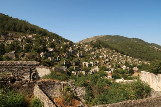 Ruins of houses in the abandoned village of Kayaköy, Livissi, close to Fethiye, Turkey 2022