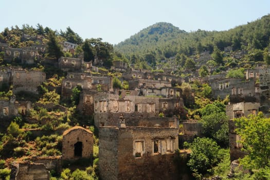 Remains of houses on a hill in the abandoned village of Kayaköy, Livissi, close to Fethiye, Turkey 2022