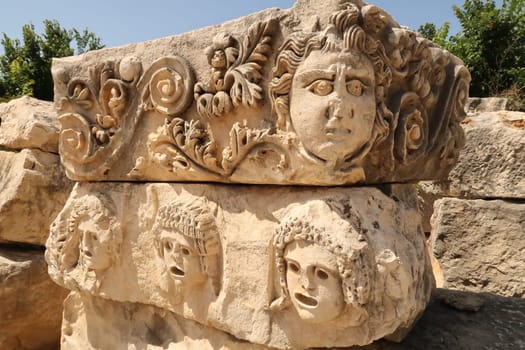 Two stones with elaborate stone reliefs, theater masks and ornaments in the ancient town of Myra, near Demre, Turkey 2022