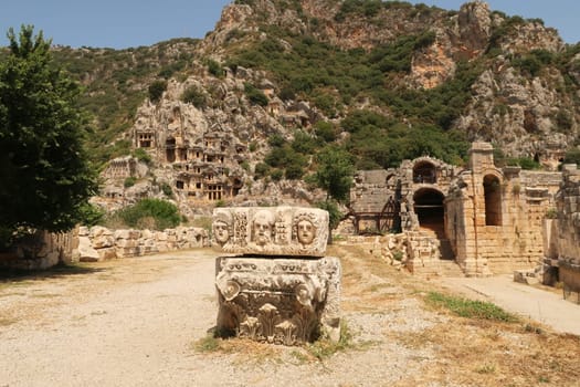 The entrance area to the ancient city of Myra, with a stone relief in the front and the tombs and the amphitheater in the back, close to Demre, Turkey 2022