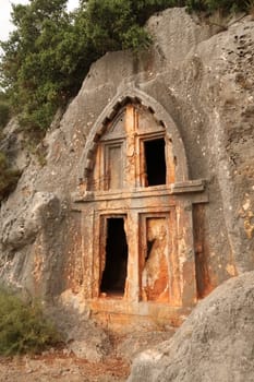 Ancient Lycian rock hewn, rock cut tomb above the coastal town of Kas, Turkey 2022