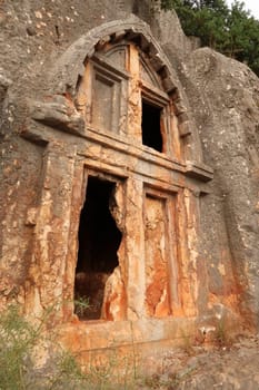 One of the ancient Lycian rock hewn, rock cut tombs above the coastal town of Kas, Turkey 2022