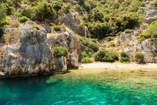 Remaining stairs leading into the water at the ancient sunken city of Kekova, Kekova Island, Demre, Turkey 2022