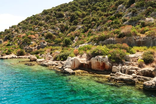 Remaining structures and walls of the ancient sunken city of Kekova on the shore of Kekova Island, Demre, Turkey 2022