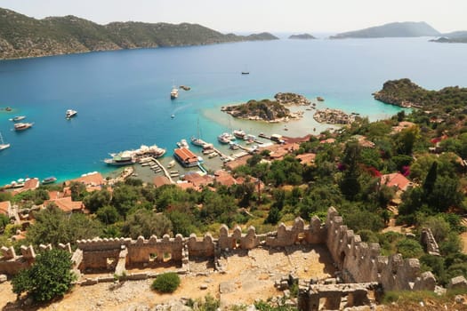 The view from the ancient Simena Castle onto the coastal town of Kaleköy and the mediterranean sea, close to Demre, Turkey 2022