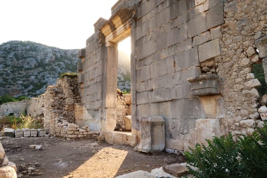 Golden hour at the giant sella, cella door, entrance to Ionic Temple at the ancient site of Olympos, Olympus, built in the name of the Roman Emperor Marcus Aurelius, close to Antalya, Turkey 2022