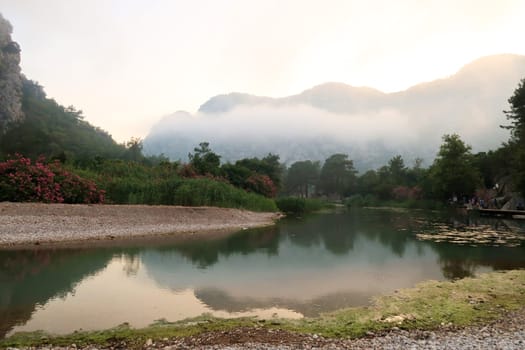 Evening fog coming up at beautiful lagoon next to the ruins of the ancient site of Olympos, Olympus, close to Antalya, Turkey 2022