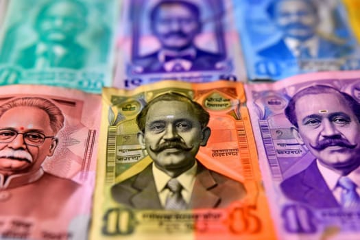 A man stands in the center surrounded by a pile of Indian currency notes, representing wealth and prosperity.