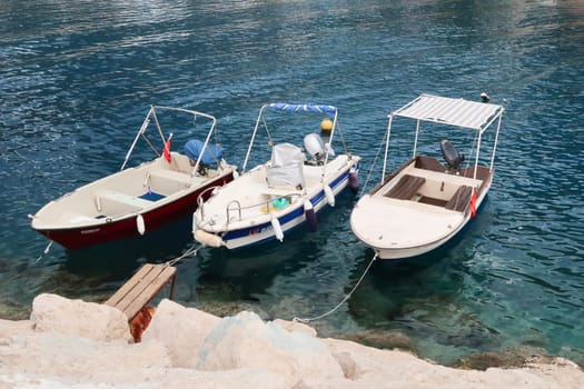 Three boats tied up in the harbour of Kas, Turkey, 26th of May 2022
