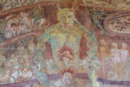 Pisa, Italy - 29 June 2023: Fresco in the Cemetery with Satan and the medieval hell, gothic design, 1464
