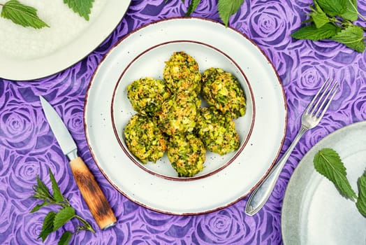 Homemade green dietary cutlets or meatballs made from young nettles. Vegetarian food. Flat lay.