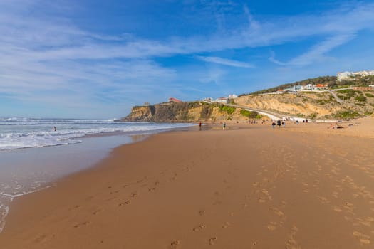 Sintra, Portugal: February 17, 2024: People at the beach of Magoito in a winter day, Sintra, Portugal