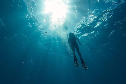 A lone diver ascends towards the sunburst above, surrounded by the serene blue of the oceans embrace.