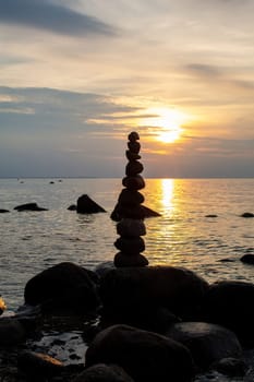 Stacked stones on a beach on the Baltic Sea coast at sunset