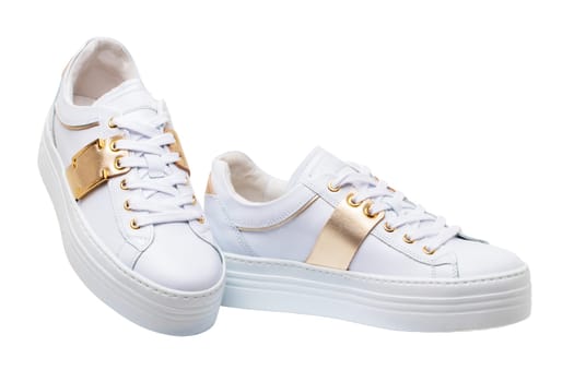 White sneaker isolated. Close-up of a pair white elegant stylish female leather high-heeled sport shoes isolated. Clipping path. Womens shoe fashion. Modern design footwear for workout.