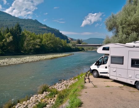 RV camper is parked by a stream in a beautiful, quiet valley