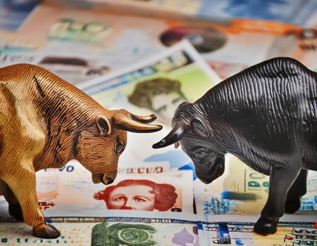 The animals of the stock exchange, bull and bear, face each other brightly on the stock exchange.
