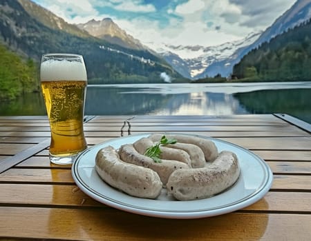Oktoberfest white sausages with pretzel and beer on a plate in the background of a lake