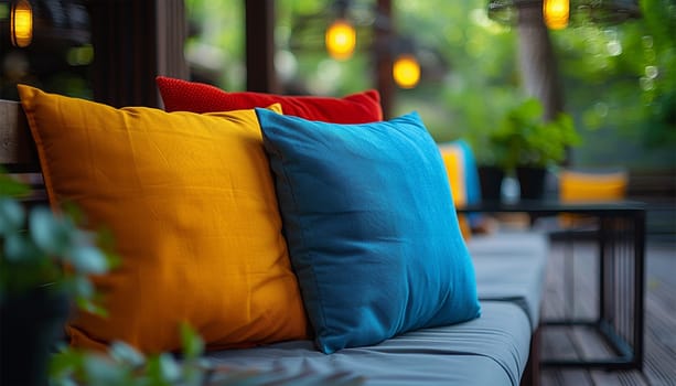 Colorful garden pillows cute, cozy furniture with colorful pillows at summer patio, lounge outdoor space. Summer design Close-up