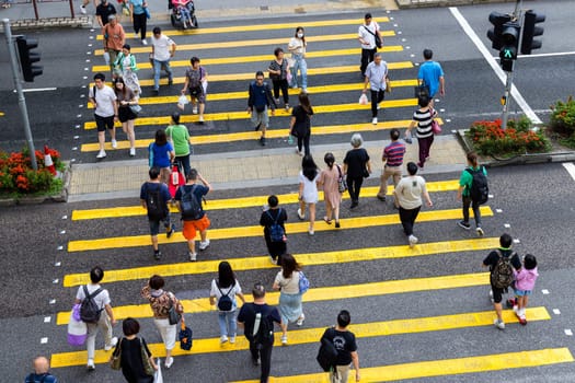 Hong Kong 28 April 2024: Top down view of people cross the zebra road